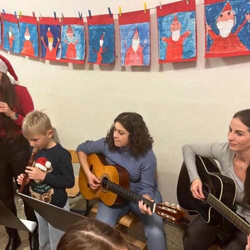 Lehrpersonen und Schüler spielen mit Instrumenten