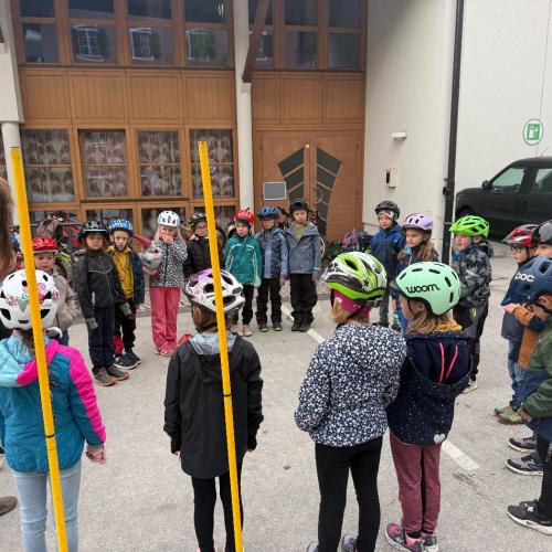 Kinder stehen im Kreis und hören Trainerin zu