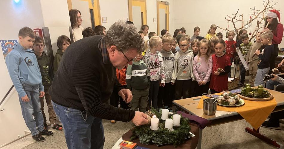 Schulleiter zündet die erste Kerze an